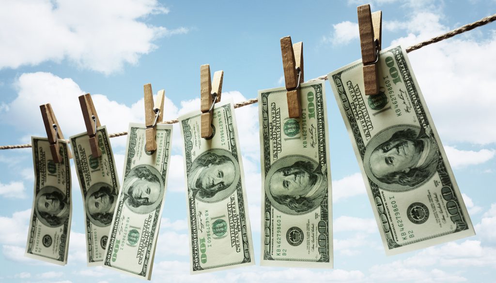 Hundred dollar bills hanging from a clothesline