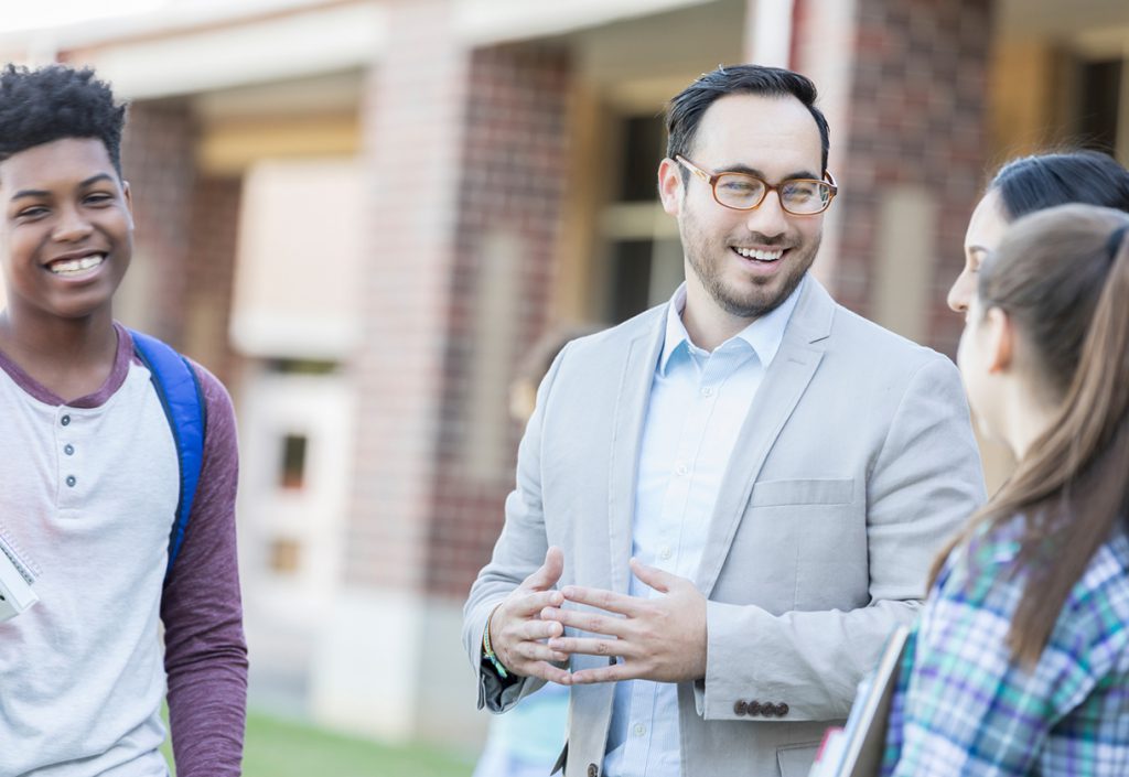 School principal talks with students