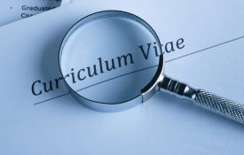 A curriculum vital and a magnifying glass