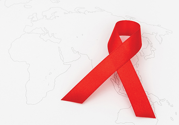 This is a photo of an AIDS ribbon on a world map.