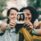 Friends holding a Polaroid photo they took of themselves
