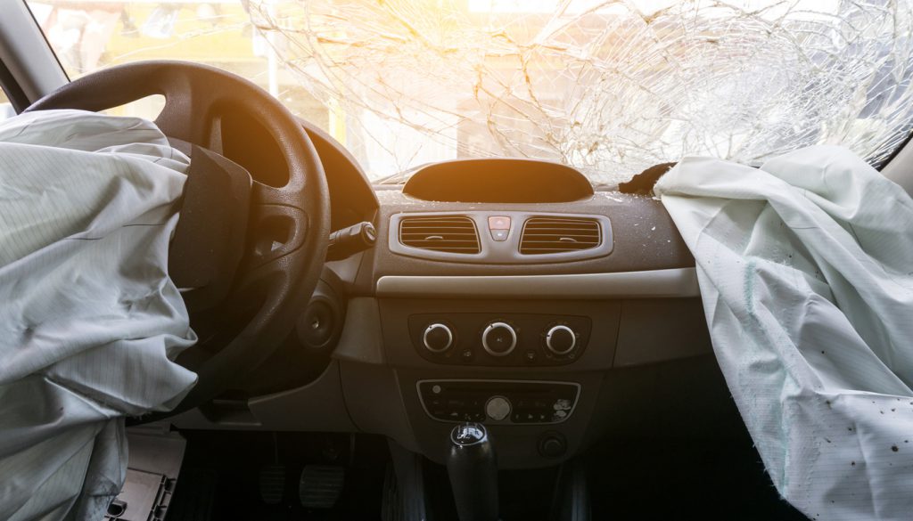 Damaged car dashboard with airbags deployed