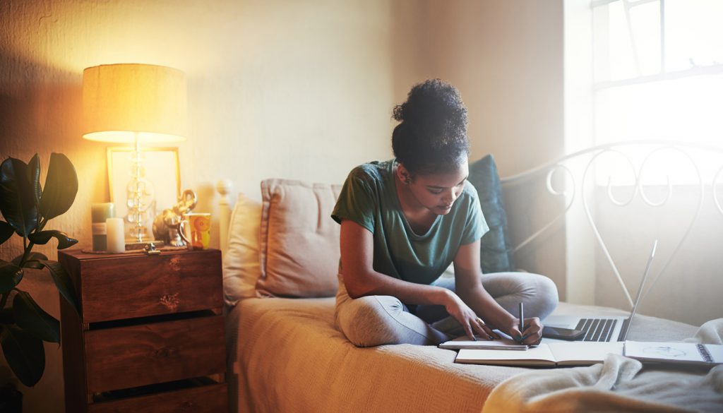 Full length shot of a young female student studying at home