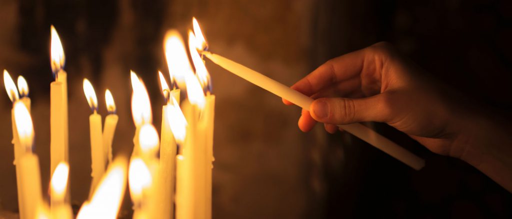 This is a picture of a person lighting a candle