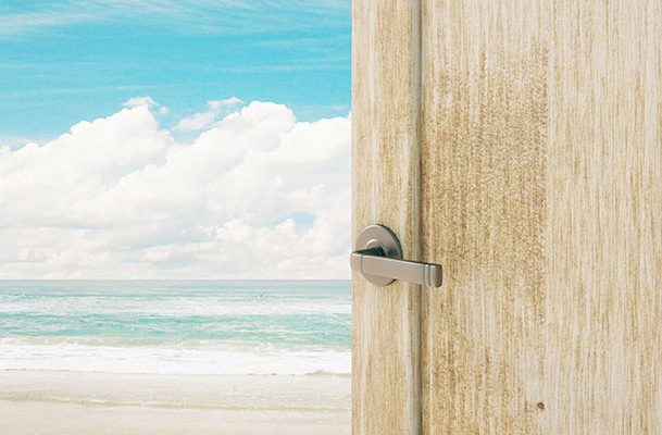 This is a photo of a door opening to a beach.