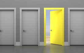 This is an illustration of a series of gray doors with one open yellow door.