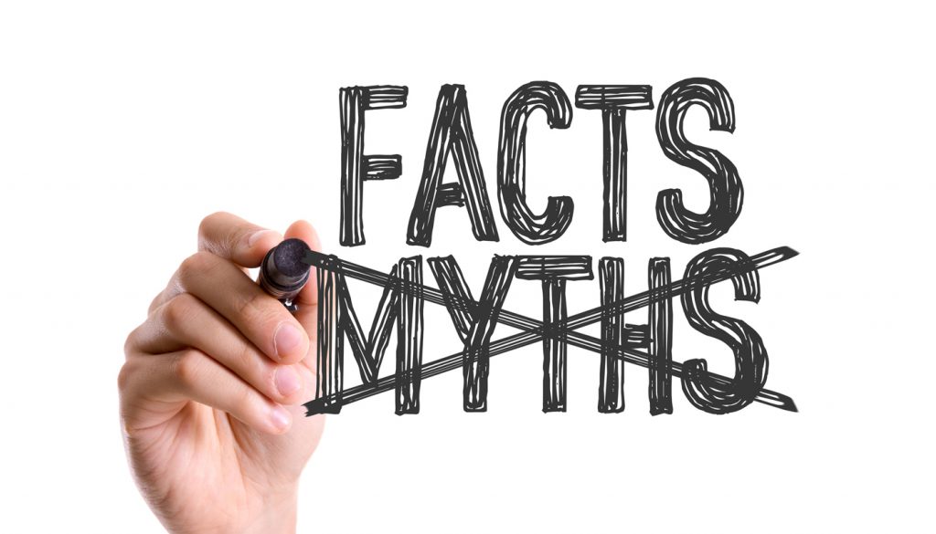 Hand with marker writing the word Facts Myths