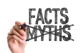 Hand with marker writing the word Facts Myths