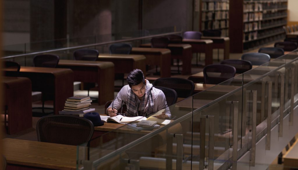 Student working in library at night