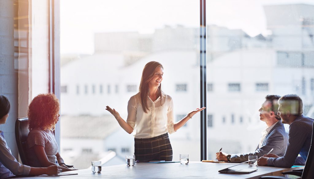 This is a photo of a business woman explaining her ideas to coworkers