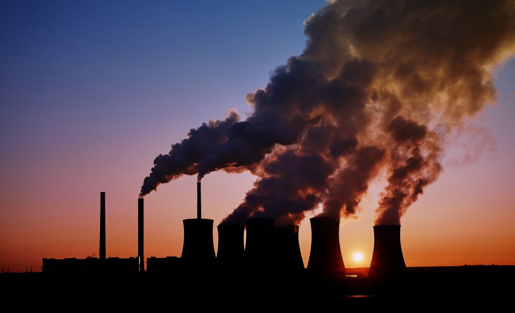 This is a photo of a coal-fired power station taken at sunset.