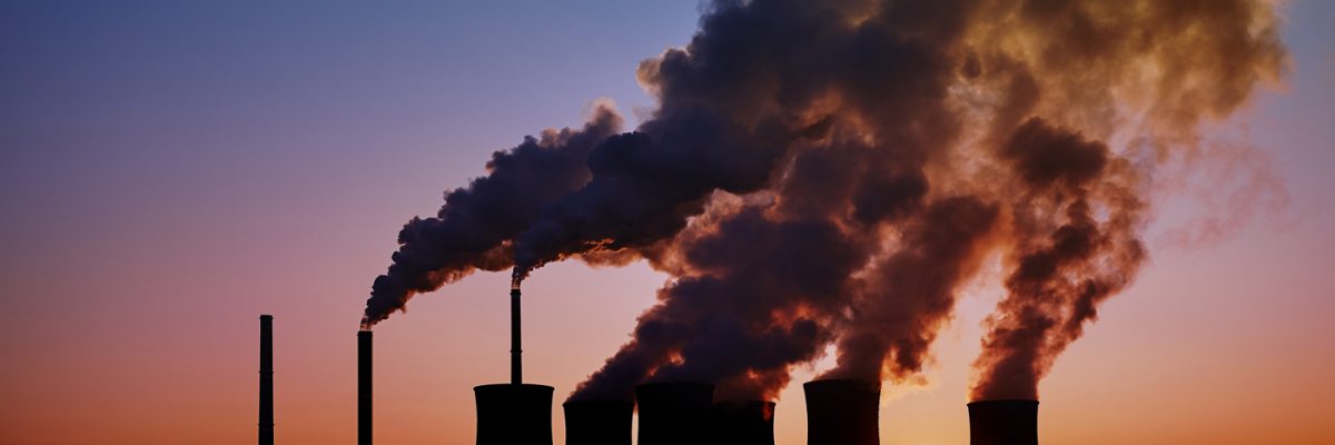 This is a photo of a coal-fired power station taken at sunset.