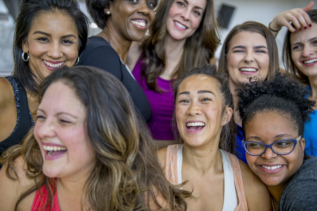 A diverse group of women laughing