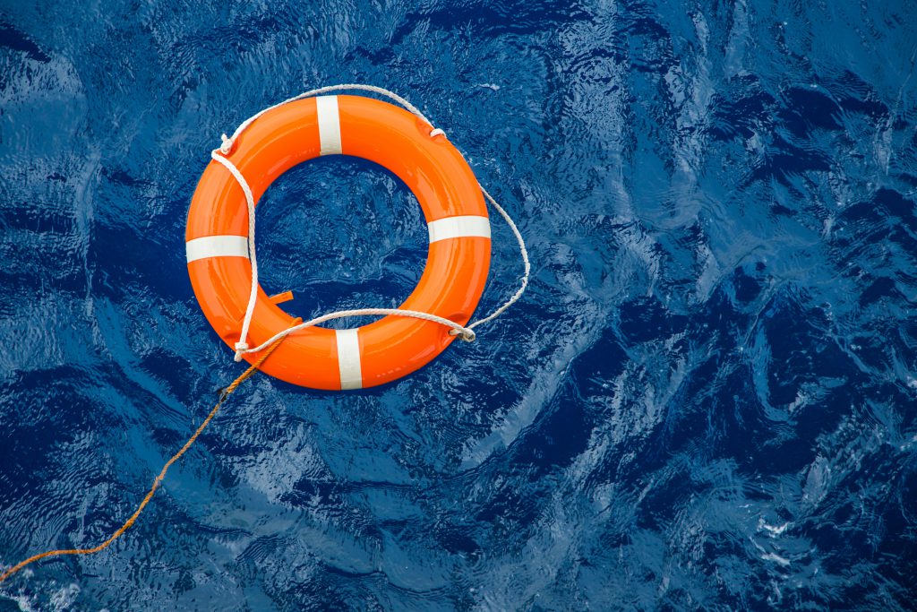 Life preserver ring floating in water