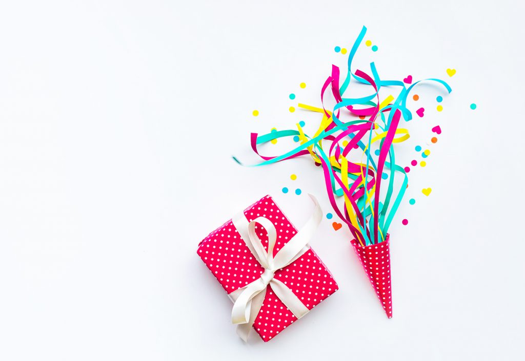Colorful confetti,streamers and gift box.Flat lay