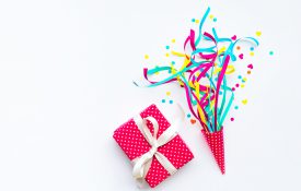 Colorful confetti,streamers and gift box.Flat lay