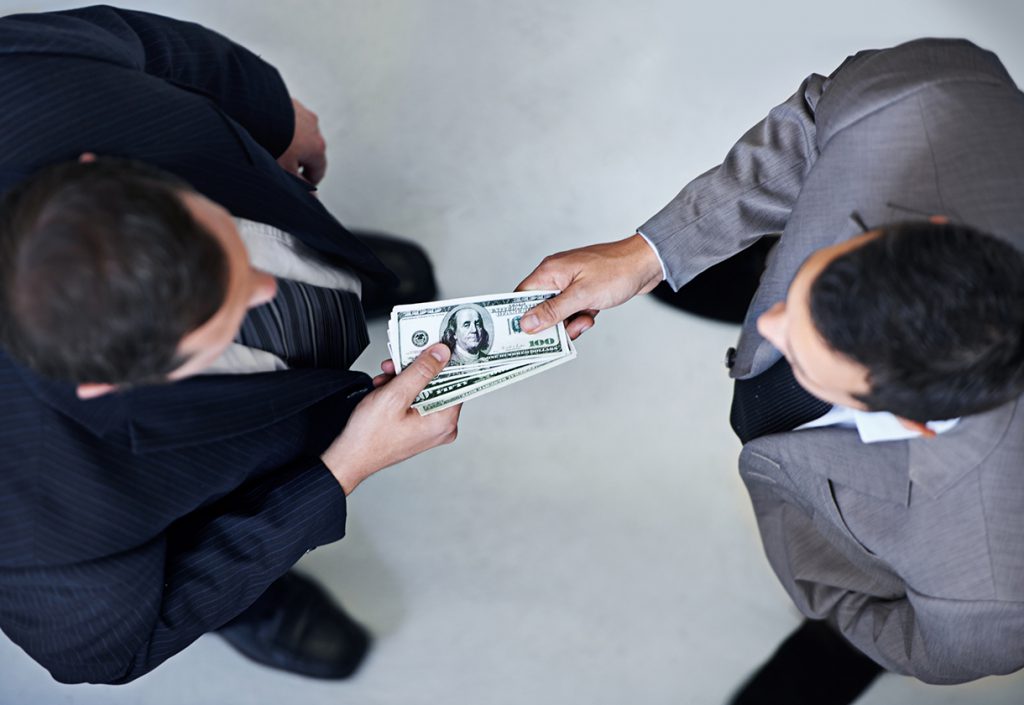 This is a photo of two men exchanging cash