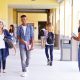 Group Of High School Students Walking Along Hallway