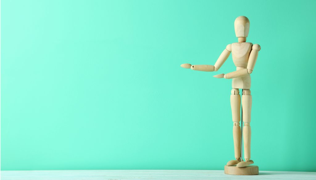 Wooden figure on a green wooden table