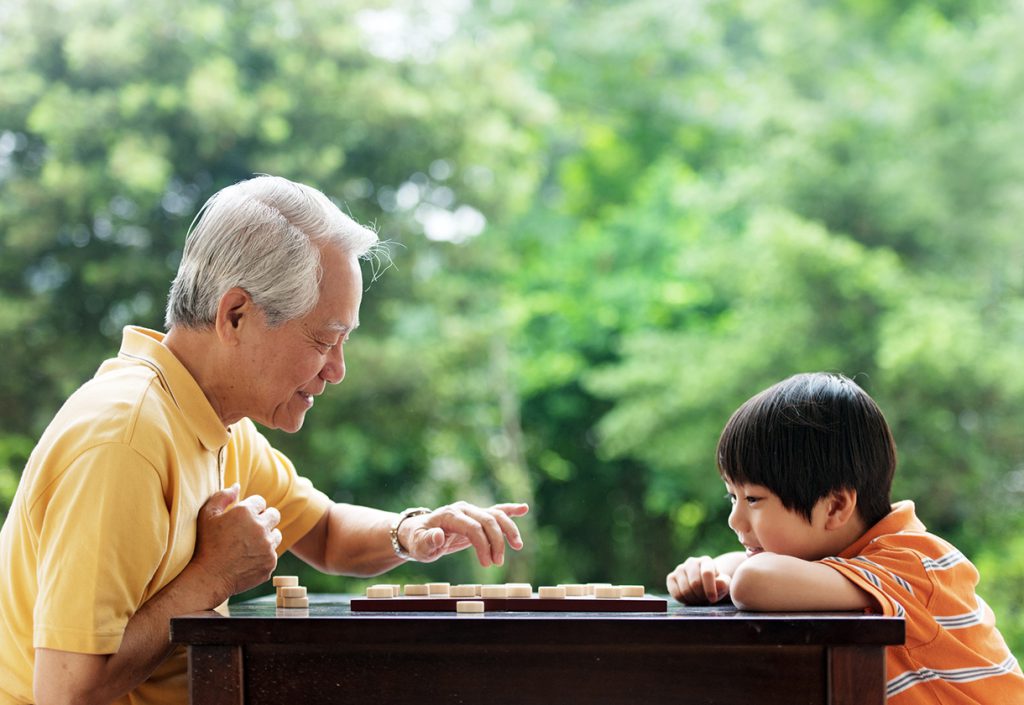 Grandfather and grandson playing Xiangqi (chinese chess)