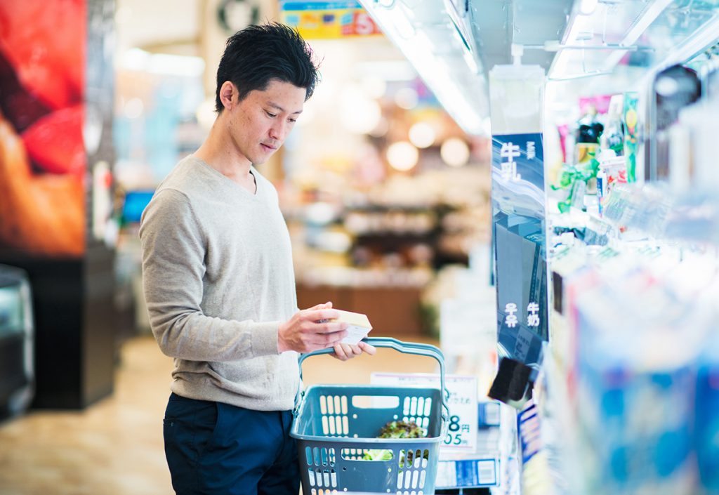 This is a photo of an adult male grocery shopping in a supermarket