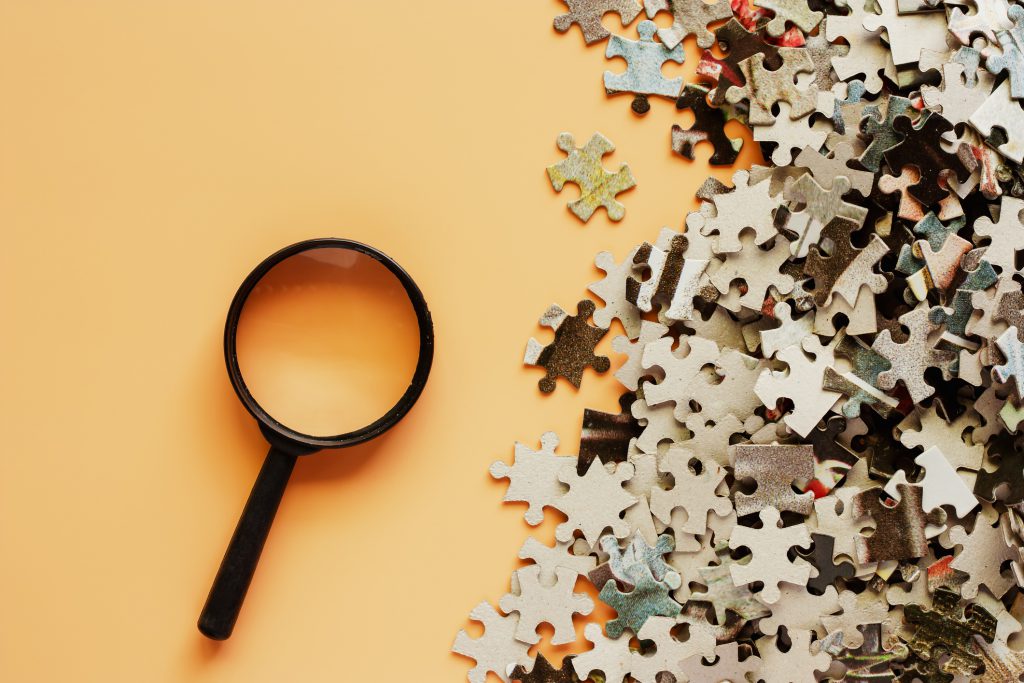 magnifying glass and puzzle pieces