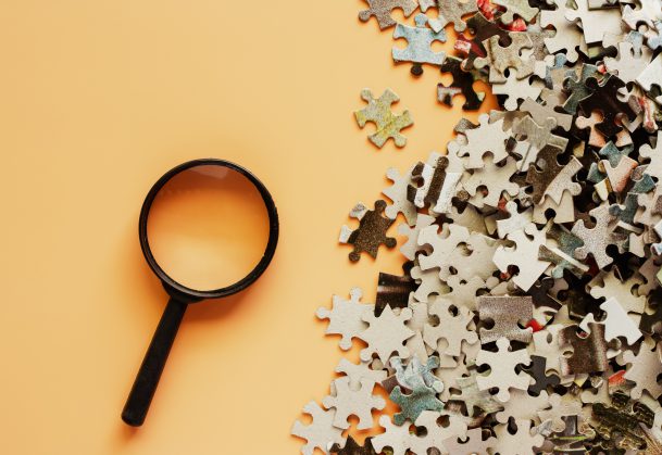 magnifying glass and puzzle pieces