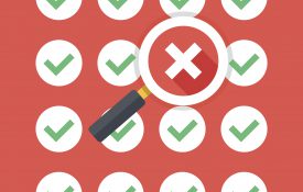 Magnifying glass hovering over a red X error symbol in a matrix of green checkmarks