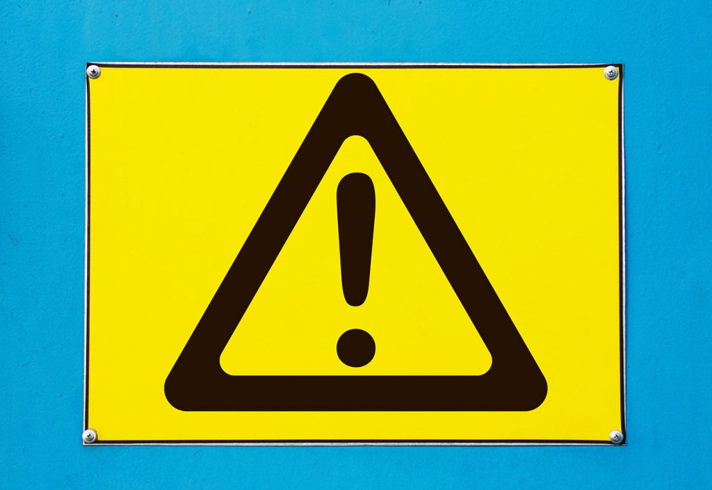 Outdoor attention sign - yellow triangle with exclamation.