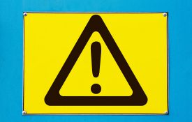 Outdoor attention sign - yellow triangle with exclamation.