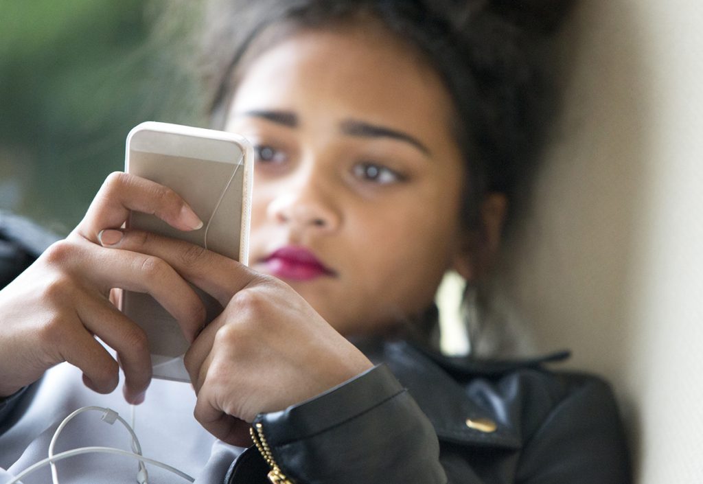 Teenager on her mobile phone