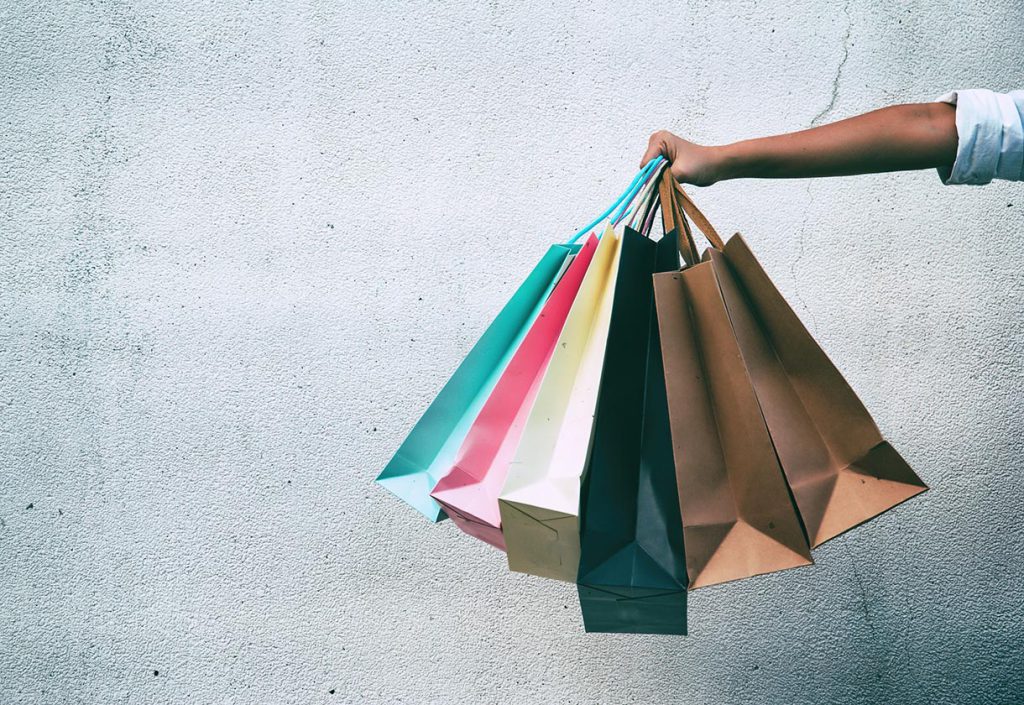 Closeup of hand holding shopping bags