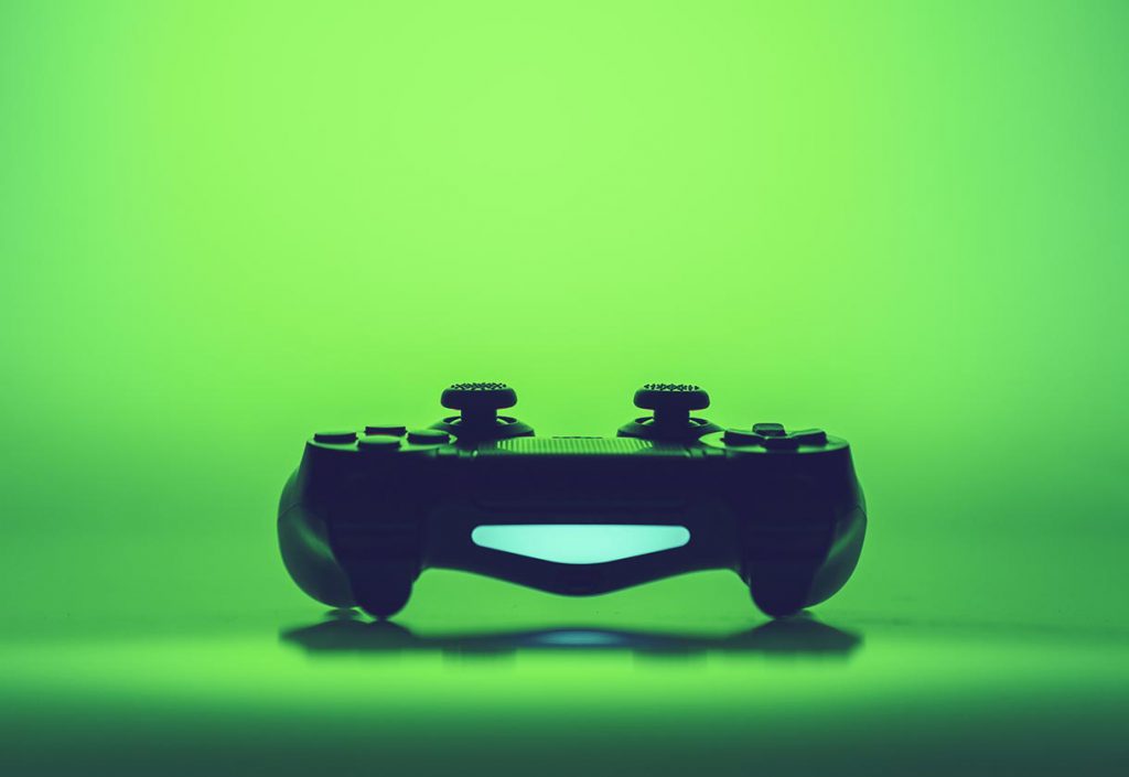 Video game controller on a vivid green background