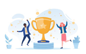 Two people cheering next to an award.