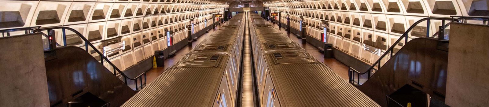 Wide shot of one of DC's metro stations, with two trains at the station.