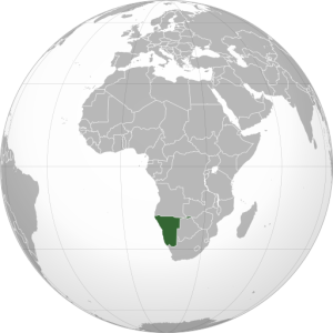 A gray orthographic projection of the world with Nabibia highlighted in green.