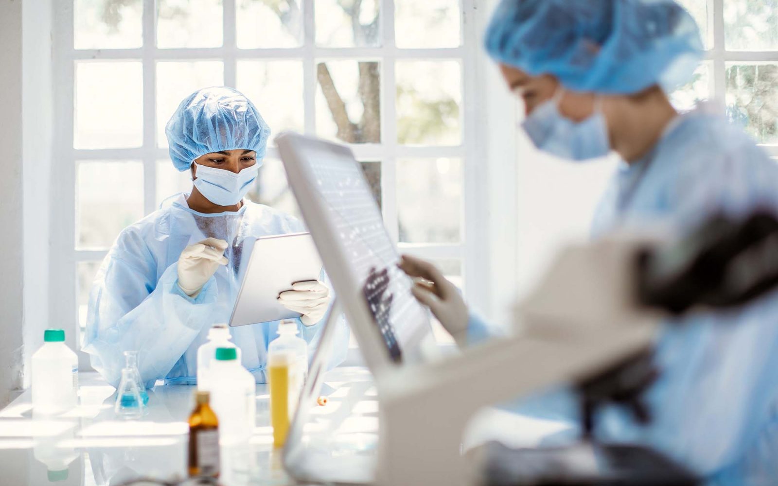 People in masks work in a lab