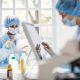 People in masks work in a lab