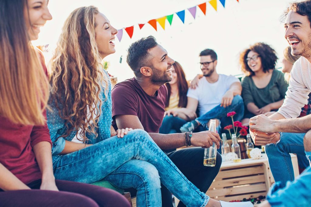 A group of young adults drinking outdoors.