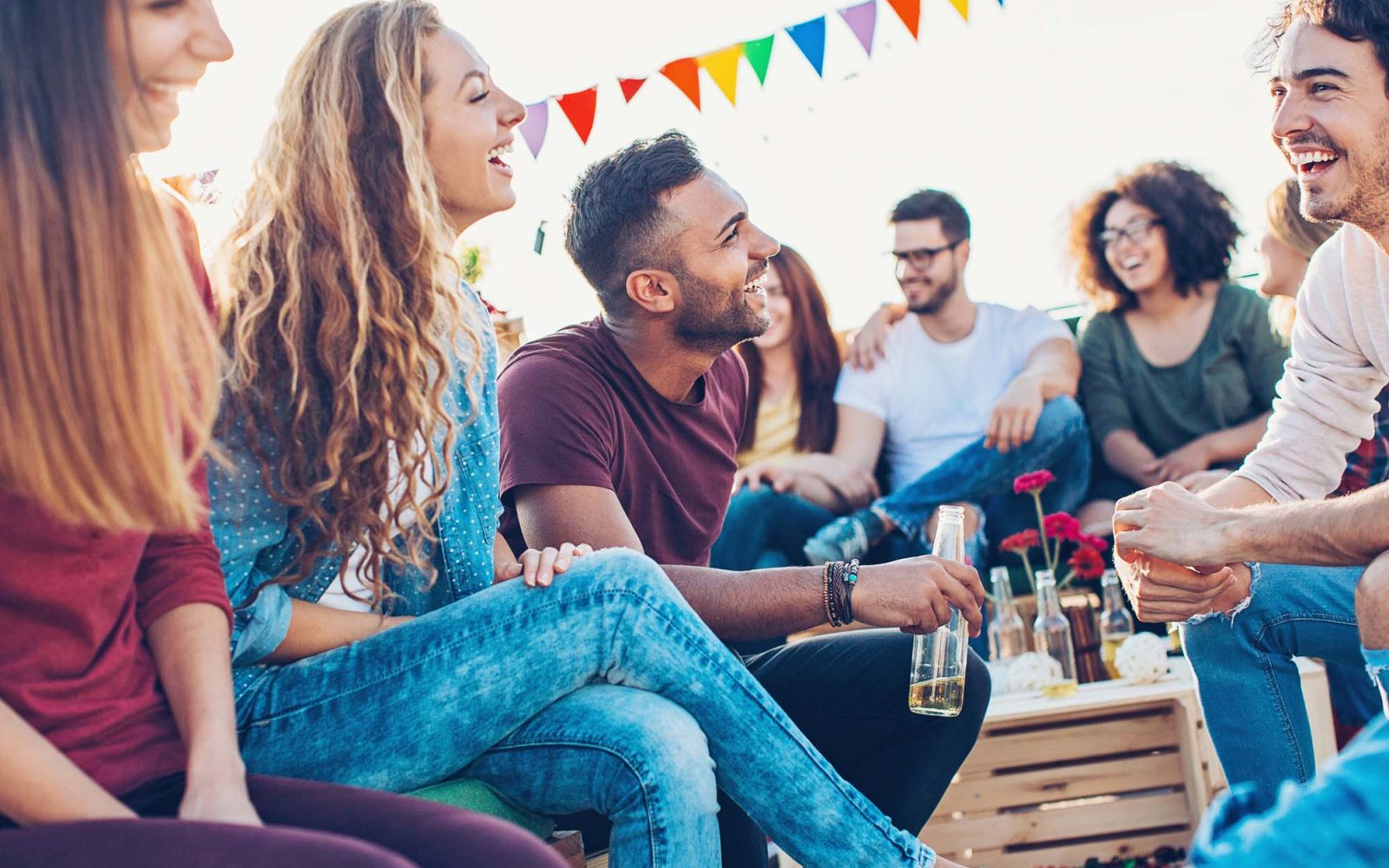 A group of young adults drinking outdoors.