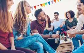 A group of young adults drinking outdoors.
