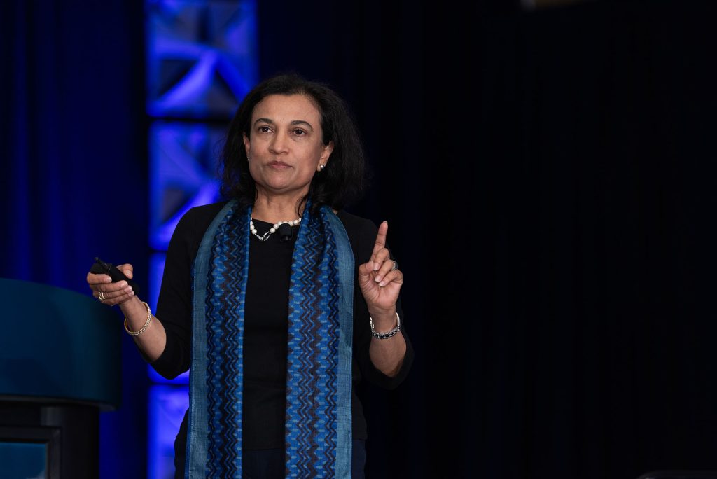 Suparna Rajaram holds her hand up while speaking during the Collective Cognition panel.