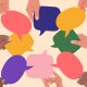 Diverse human hands holding speech bubbles.