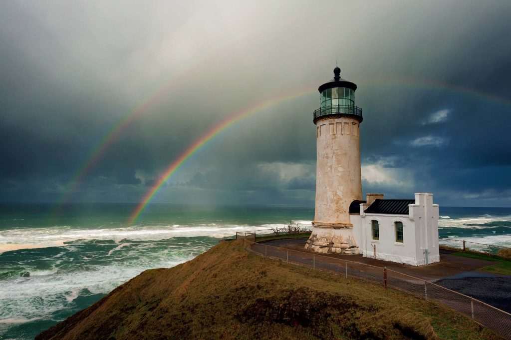 Double Rainbow stands out in the stormy rainy skies above North Head Lighthouse at the mouth of the Columbia River and the Pacific Ocean in IIwaco, Washington.