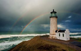 Double Rainbow stands out in the stormy rainy skies above North Head Lighthouse at the mouth of the Columbia River and the Pacific Ocean in IIwaco, Washington.
