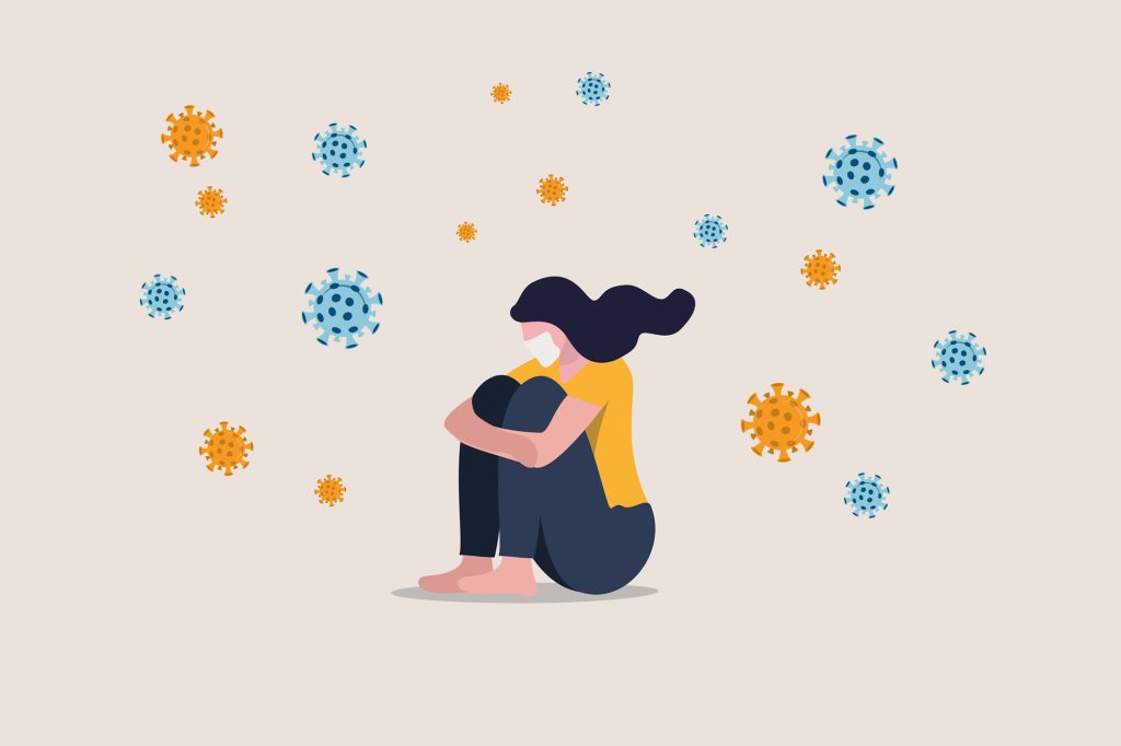 Infographic of a woman sitting alone with COVID-19 viruses floating around her.