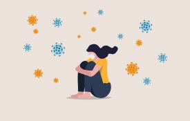 Infographic of a woman sitting alone with COVID-19 viruses floating around her.