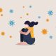 Infographic of a woman sitting alone with COVID-19 viruses floating around her.