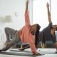 Couple doing yoga in their living room