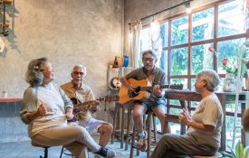 Group of seniors playing guitar.